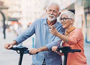 Elderly couple on scooters